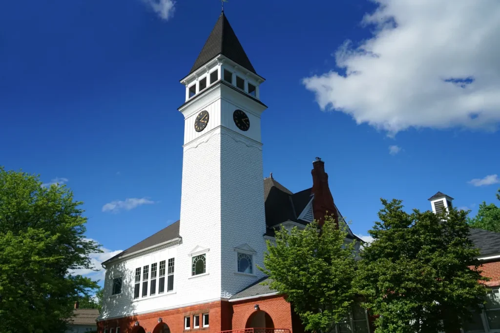 Historic clock tower building in Hollis, New Hampshire under a blue sky