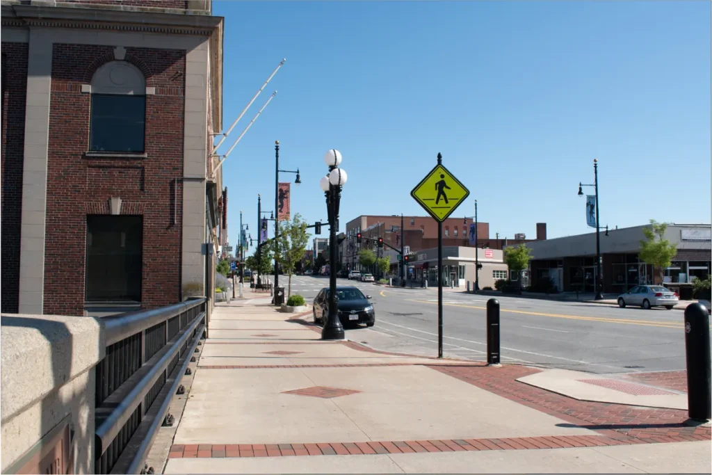 Main Street in downtown Nashua, New Hampshire, with brick storefronts and street lamps